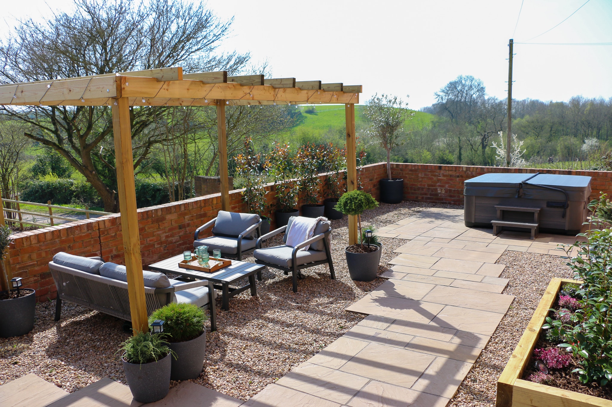 Outdoor patio with seating area and hot tub