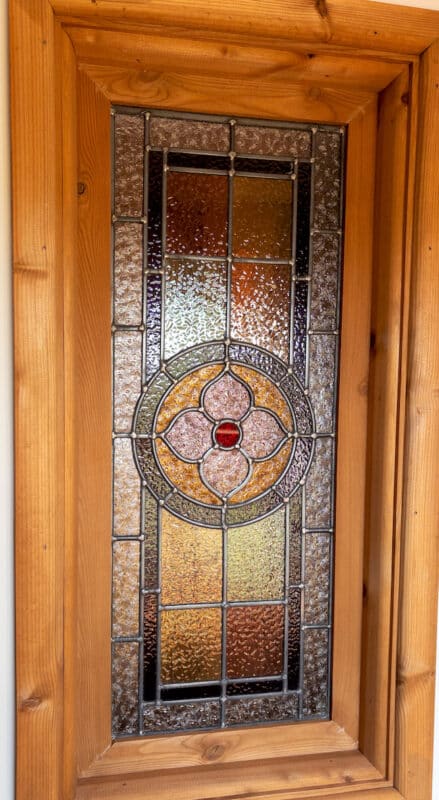 Vintage stained glass windows at Derbyshire holiday lodge near Peak District.