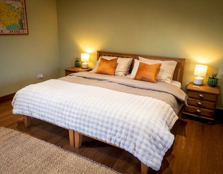 Second bedroom arranged with a super king bed and soft white bedding
