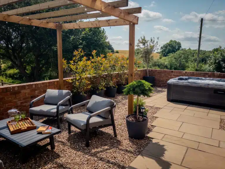 Private patio with a hot tub, outdoor seating and views across the fields