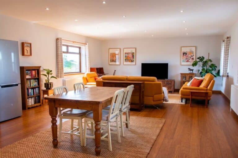 Spacious open-plan kitchen, dining area and living room with leather sofas