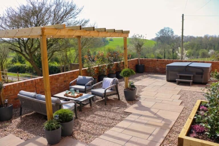 Spacious private patio with seating and a hot tub overlooking the fields